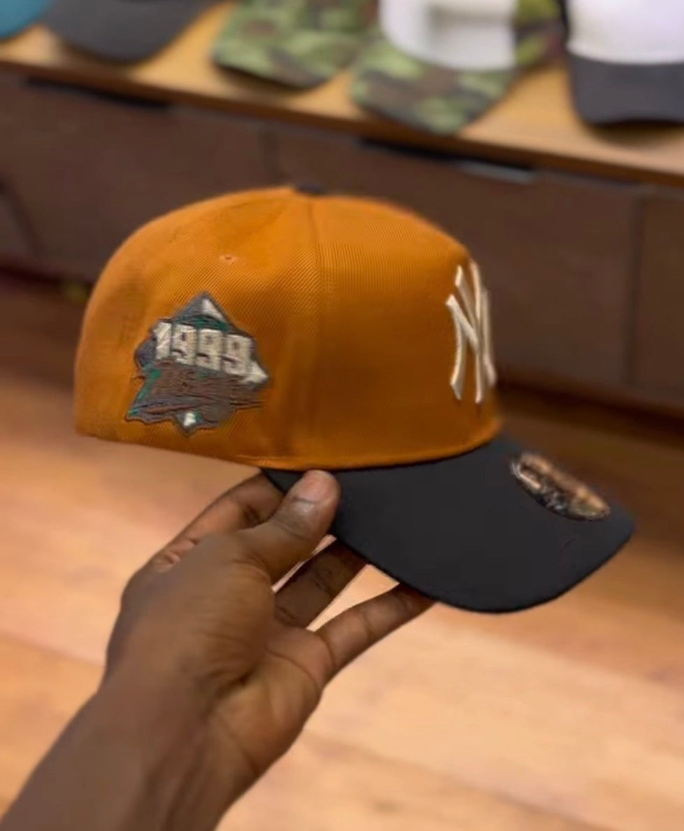 NY colorblock snapback cap
Burnt orange/black